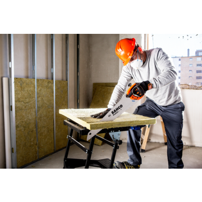 Tradesperson using the Bahco ProfCut Insulation Saw PC-22-INS to cut mineral wool insulation on site