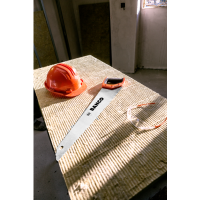 Bahco ProfCut Insulation Saw PC-22-INS laid on a mineral wool insulation slab with a hard hat, official Bahco product photography