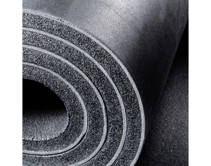 Close-up of a rolled ArmaComfort AB Alu Plus Acoustic Insulation Sheet, highlighting its black EPDM-EVA foam layers with a textured surface, demonstrating the material's thickness and flexibility for pipe insulation.